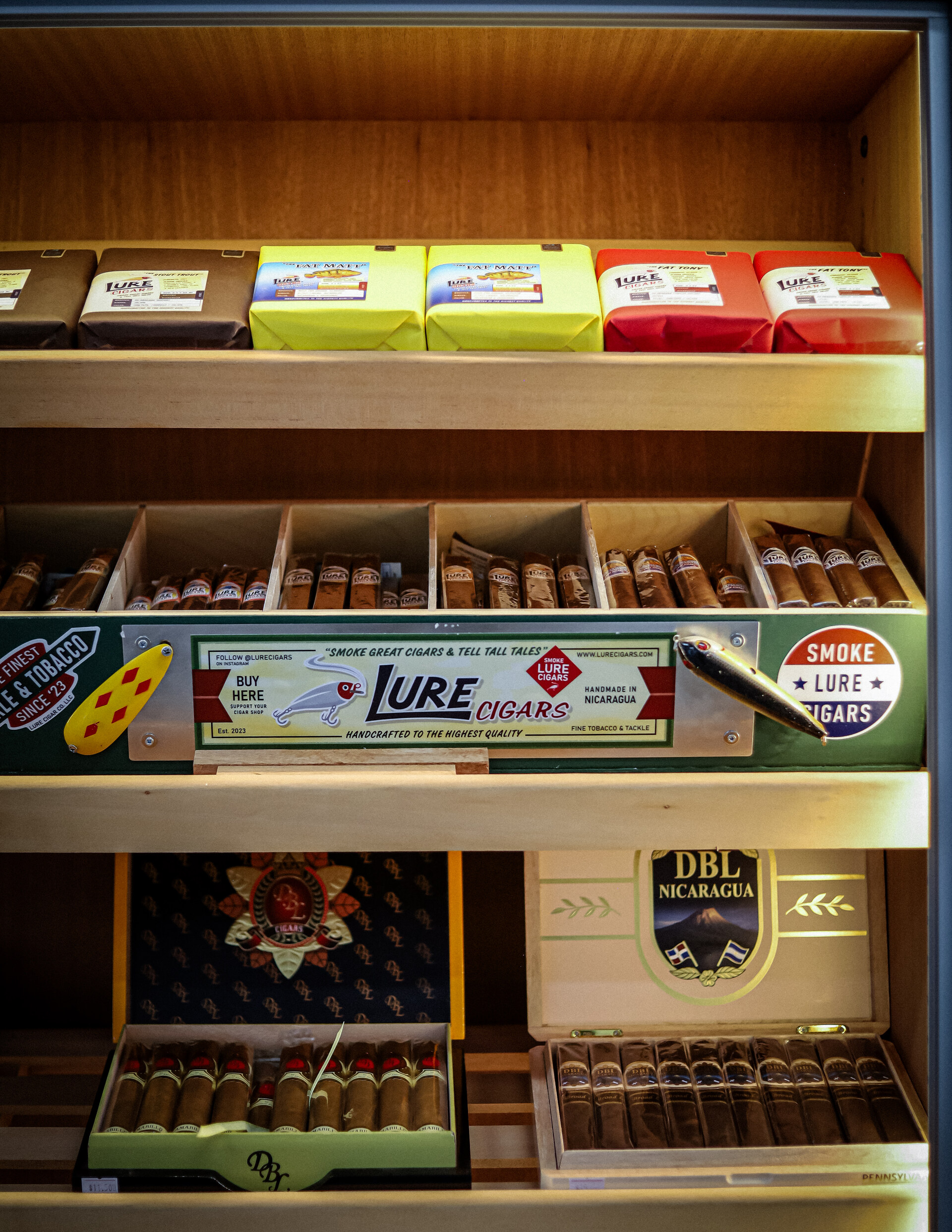 Open cigar boxes arranged on humidor shelves