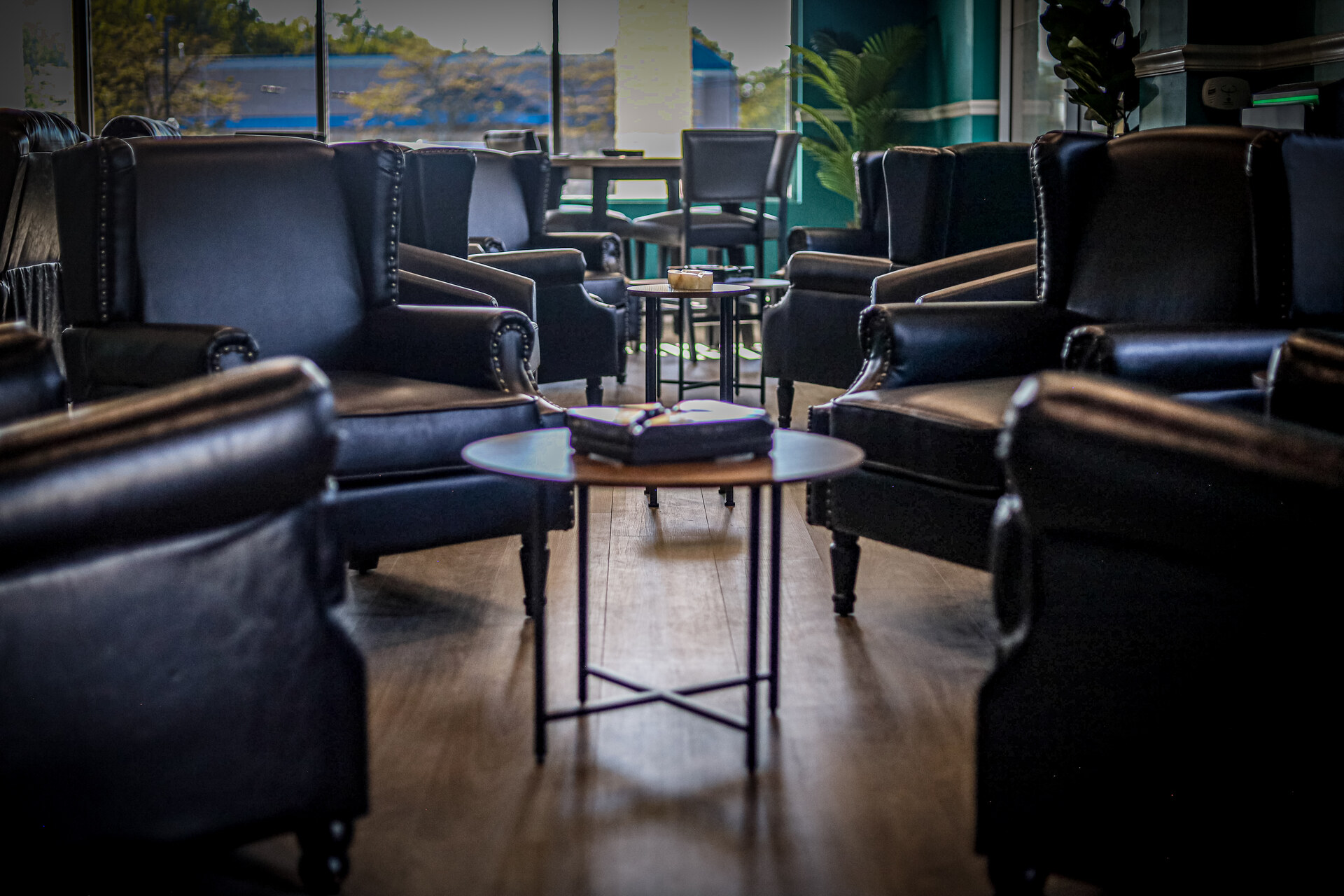 Leather lounge chairs and tables beside the front windows